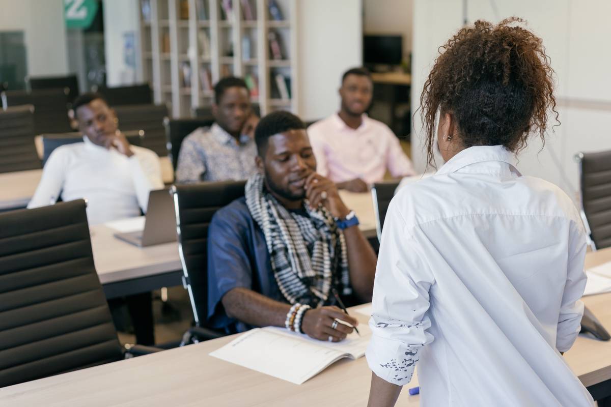 Trainer leading a professional development session with colleagues in an office training room